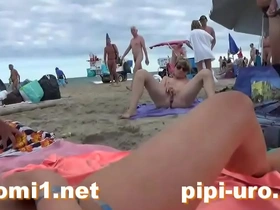 Public pussy play on the sandy shore