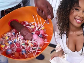 A ebony babe in a nurse costume receives more than just treats at this residence