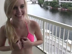 A hot bikini babe gives a steamy handjob and cumshot on the balcony